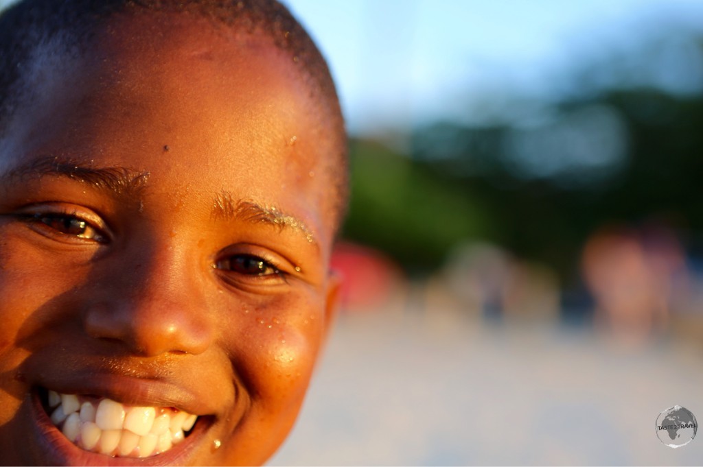A happy local boy at sunset on Grand Anse beach.