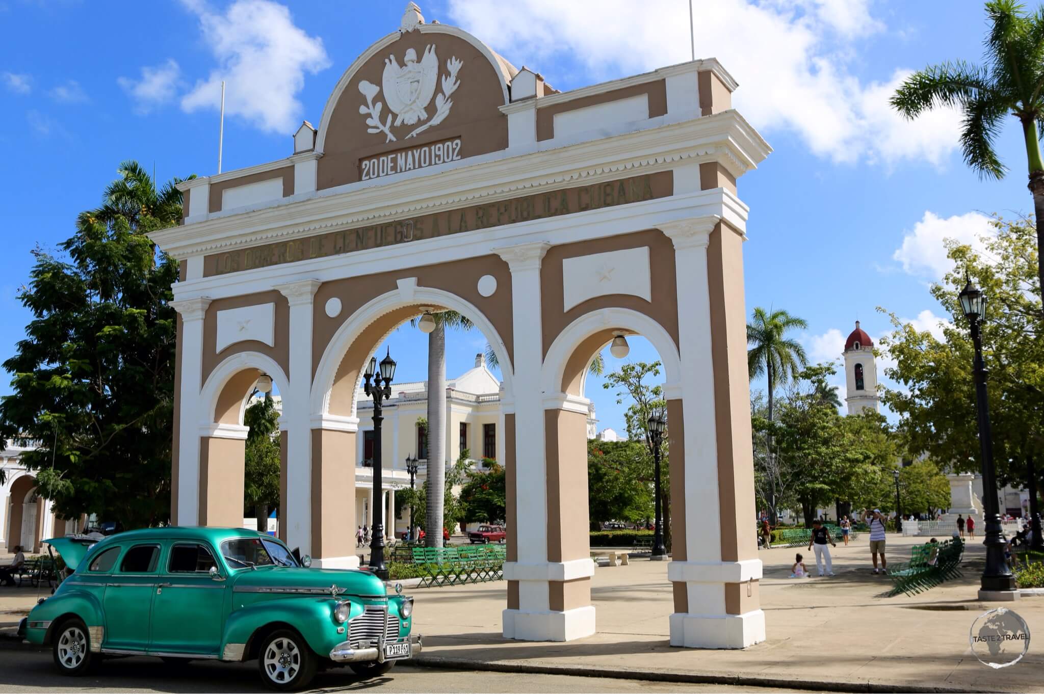 A classic American car alongside the Arco de Triunfo (Arch of Triumph) at Plaza José Martí in Cienfuegos.
