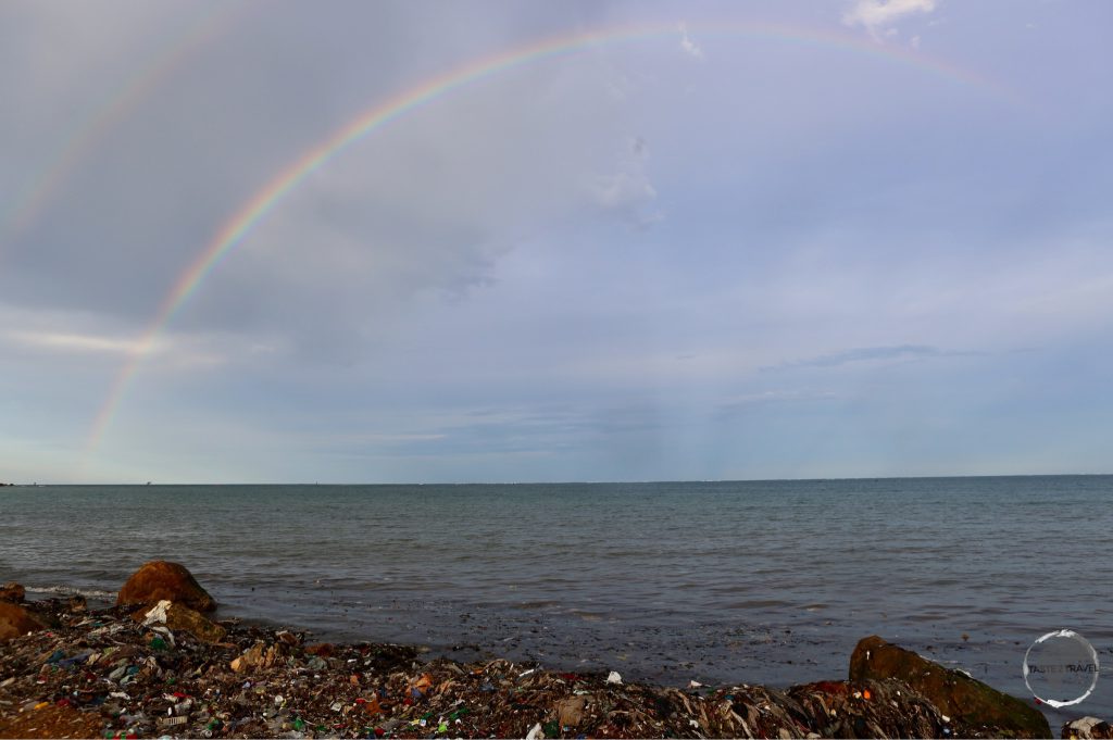Rainbow over a heavily polluted beach in CAP