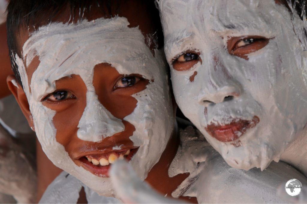 Boys taking a mud bath on Kiribati.
