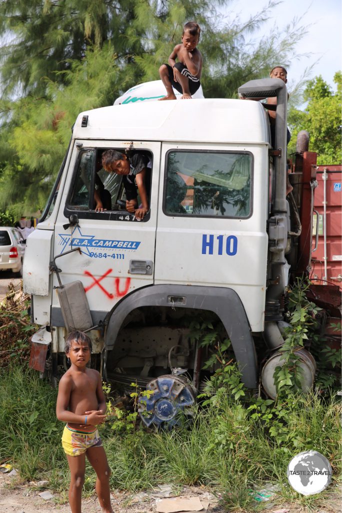An abandoned truck on Betio island serves as a playground for local boys.