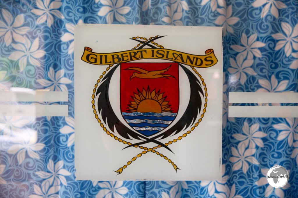 The Gilbert Islands coat of arms, displayed on the window of the General Post Office.