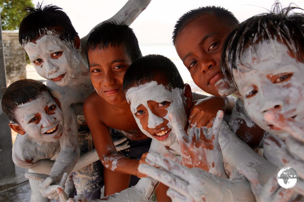 Boys enjoying a mud bath on Kiribati.