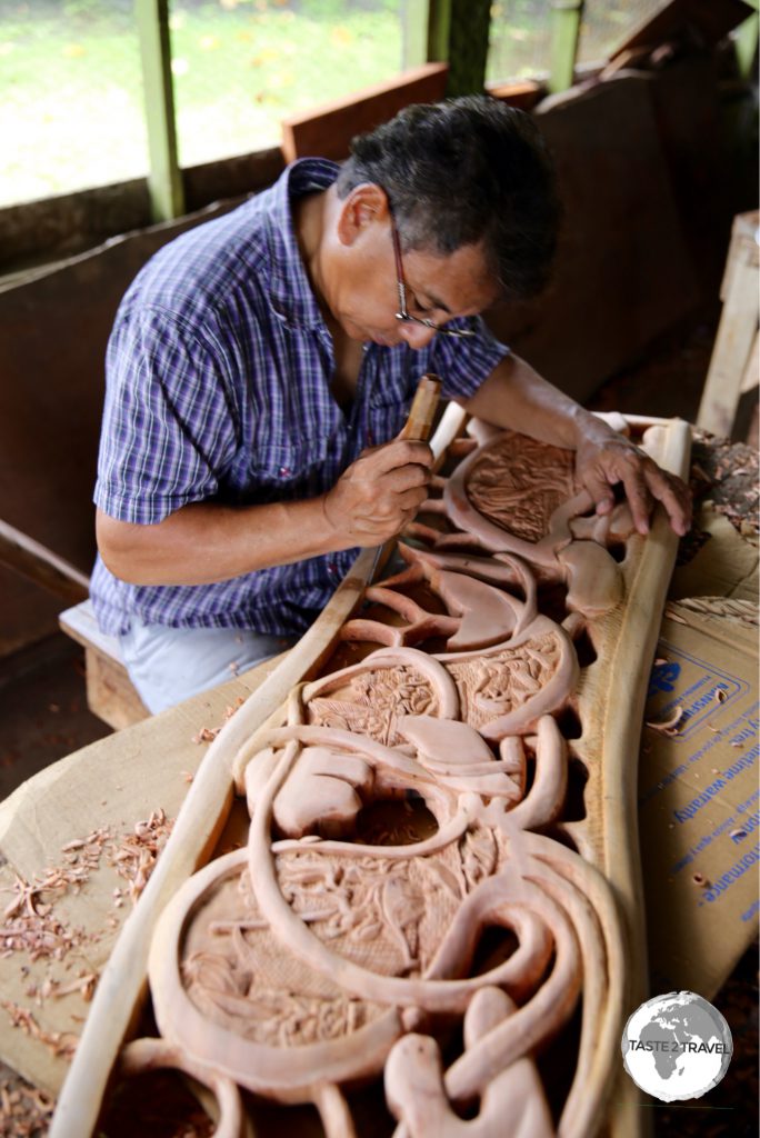 Traditional Storyboard wood carver in Koror.