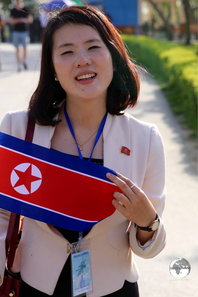 Our KITC guide at the Pyongyang zoo, holding my DPRK souvenir flag.