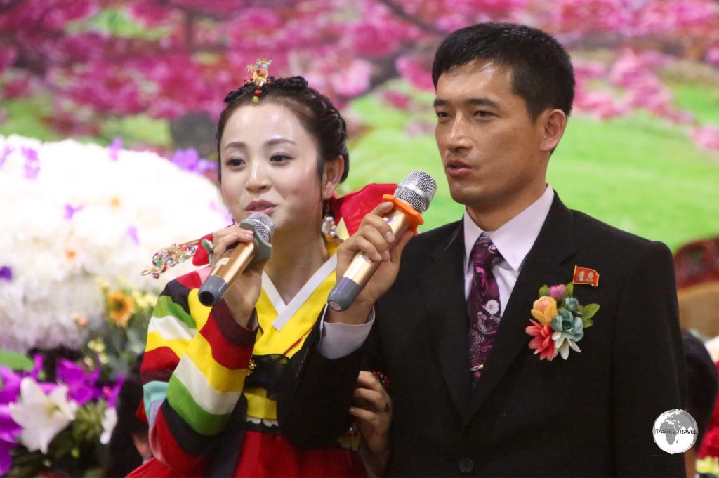 A Bride and Groom performing Karaoke at their wedding reception in Pyongyang.