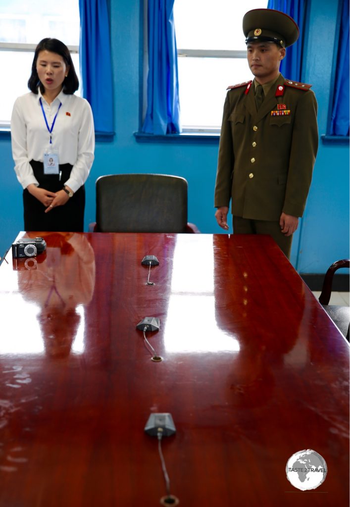 This table sits directly on the border between North And South Korea. The microphones mark the border. While in the room you are free to move from north to south.