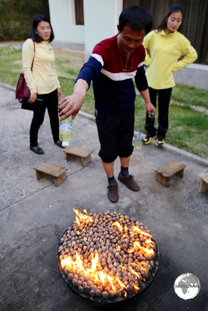 "Petrol Clams" dinner at the Ryonggang Spa Resort. Our driver pouring fuel onto the fire.