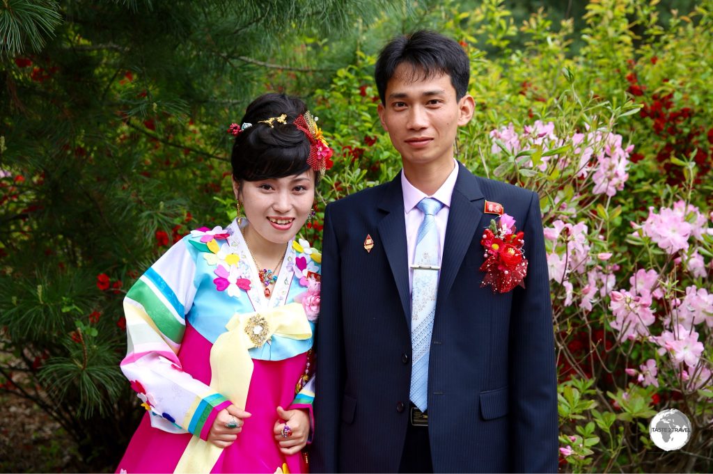 A bride and groom visiting a park near Pyongyang.
