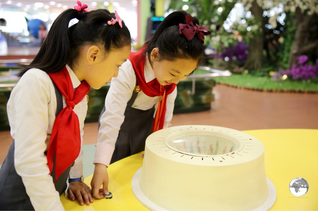 School girls playing with an interactive exhibit at the Science & Technology centre in Pyongyang.
