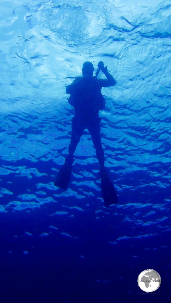 Me descending into the turquoise waters of El Nido Bay on my first dive for the day.