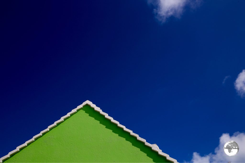 Green gable against a blue sky.