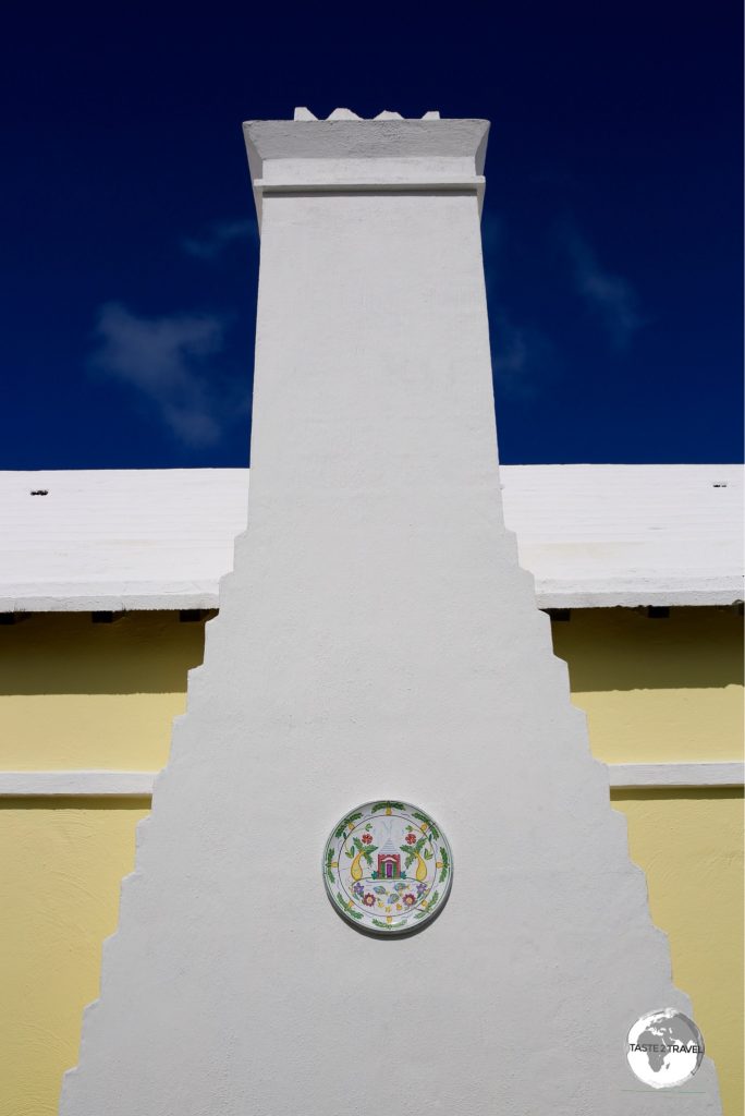 A porcelain plate embedded into a chimney in St. Georges.