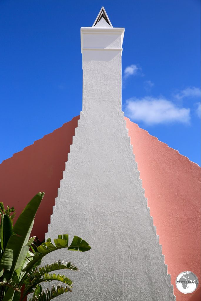 A pink gable and white chimney in St. Georges.