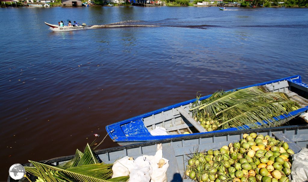 Goods from remote river communities are brought to Charity by speedboat for distribution to city market’s.