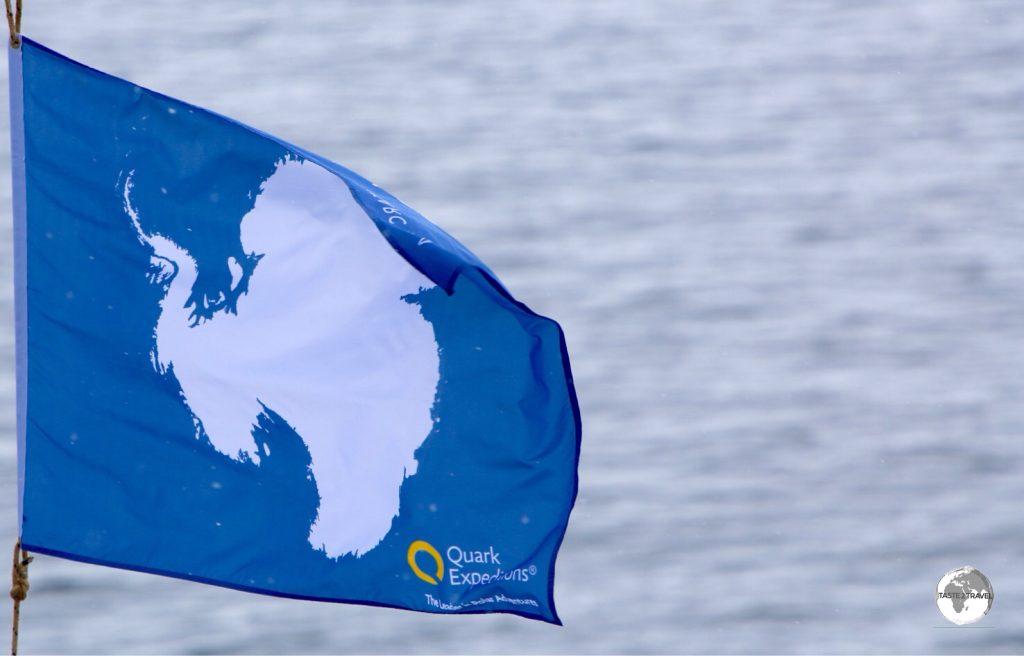 The flag of Antarctica flies on the bow of the Ocean Diamond.