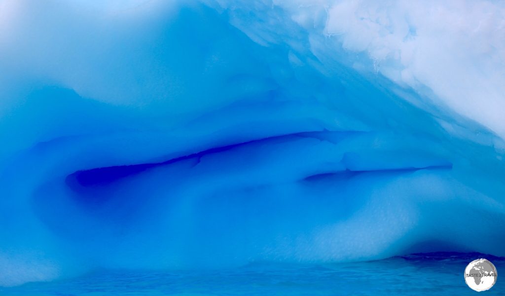 The blue glow of an iceberg in Crystal Sound provides a splash of colour in the otherwise monochrome Antarctica.