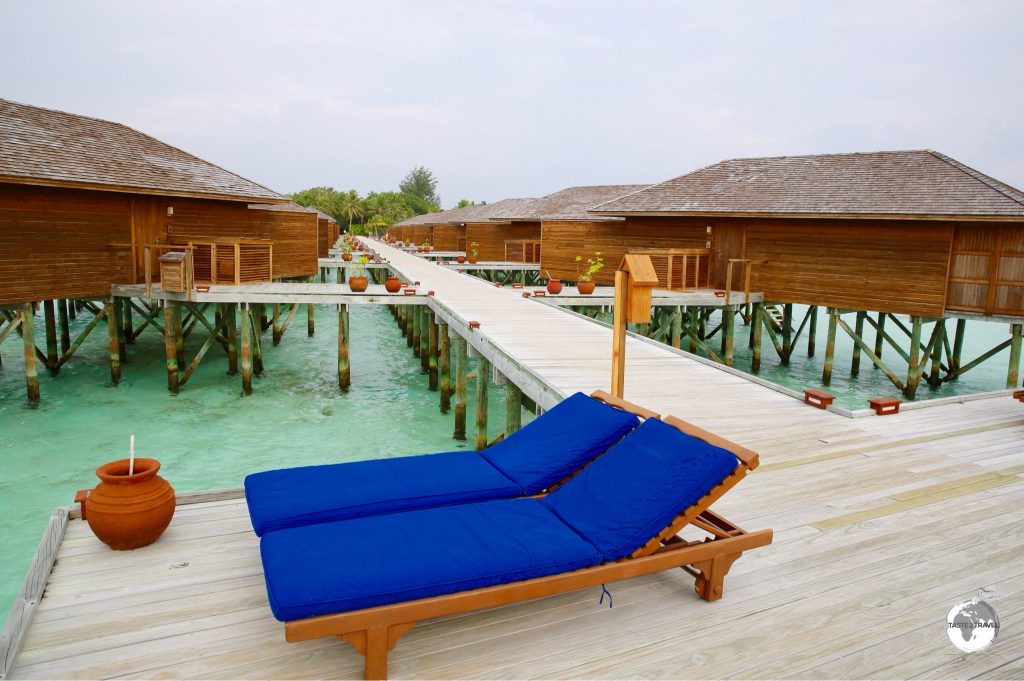 The 'Jacuzzi Water Villas' are accessed via an over-the-water boardwalk.