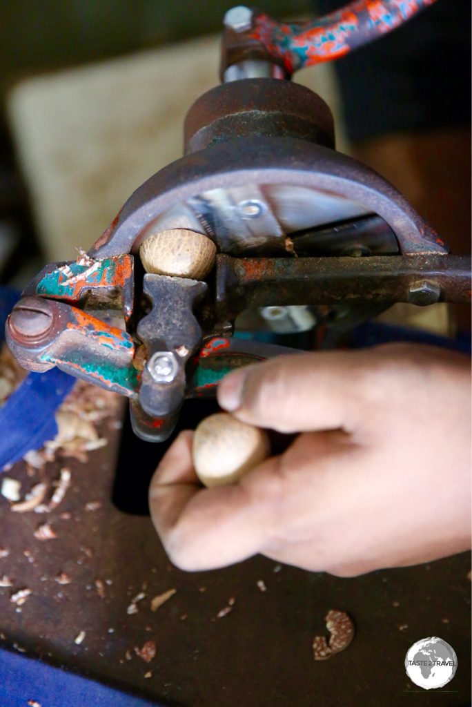 Areca nuts being sliced by hand.