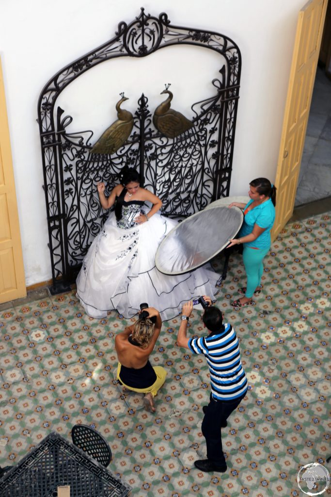 A bride being photographed inside the opulent Museo Provincial in Cienfuegos.