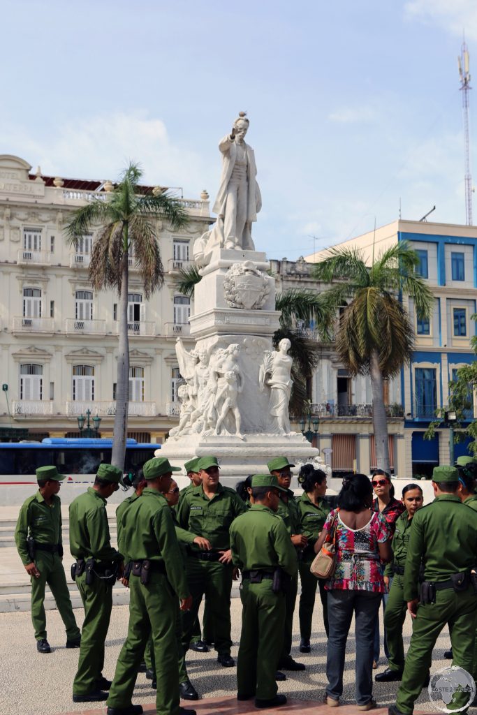Soldiers visiting a statue of José Martí in Havana.