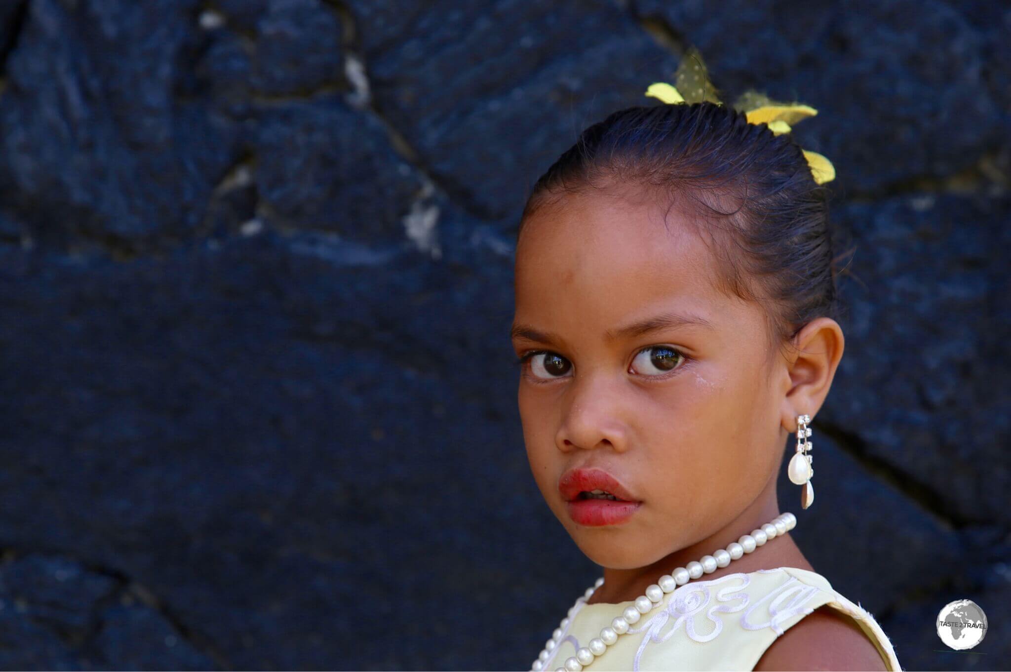A young girl on 'Eua Island, on her way to church.