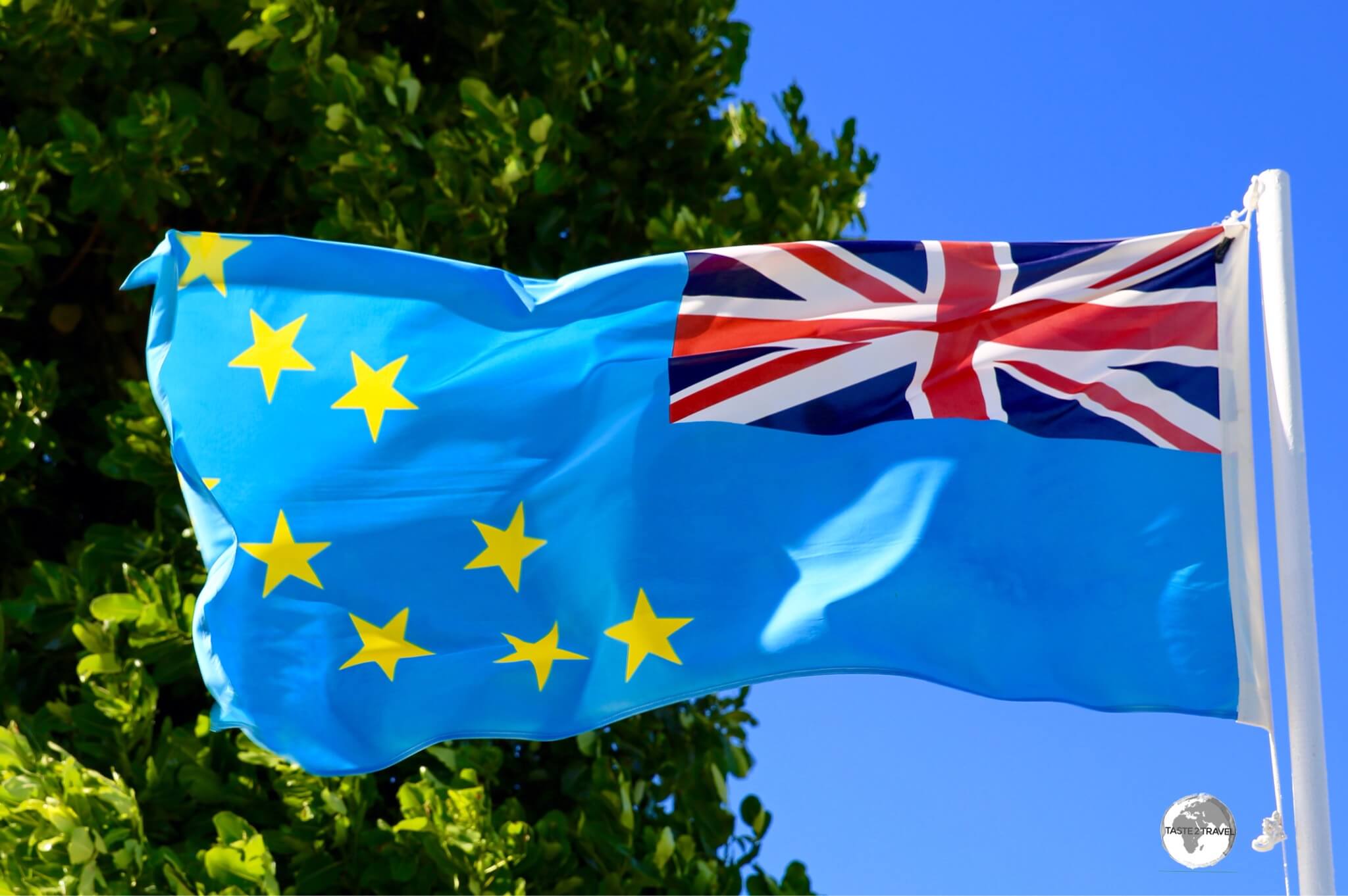 The flag of Tuvalu flying over Funafuti (seen here in reverse).