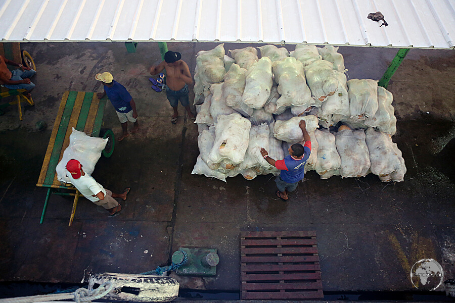 Loading sacks of coconuts onto our slow boat at the Amazonian port of Monte Alegre.