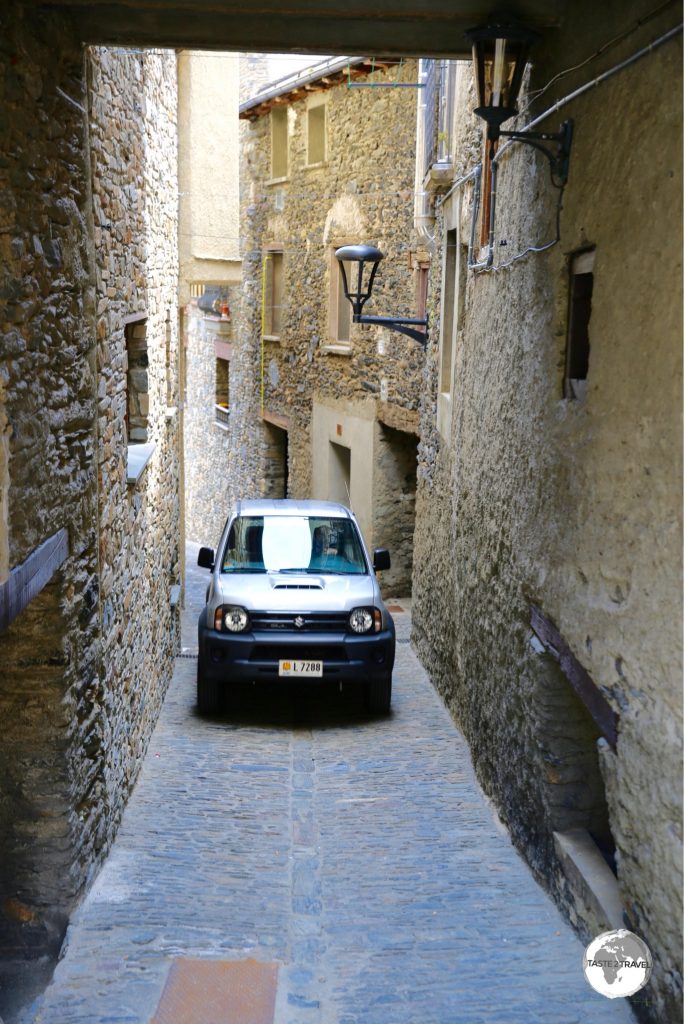Car in lane way, Ordino village, Andorra.