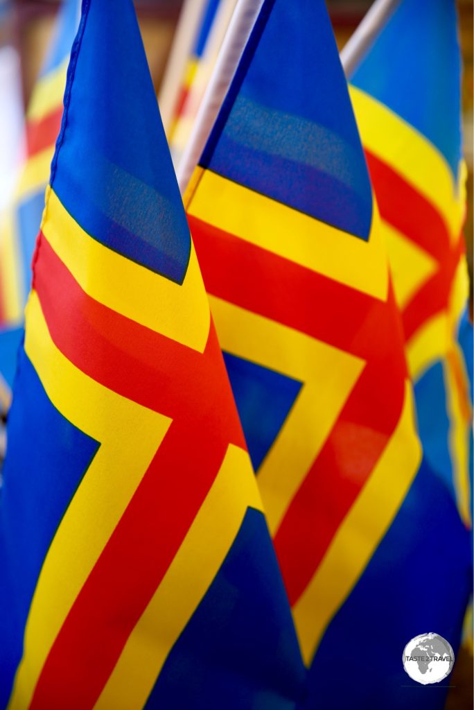 The flag of Åland is the Swedish flag defaced by a red cross symbolising Finland.