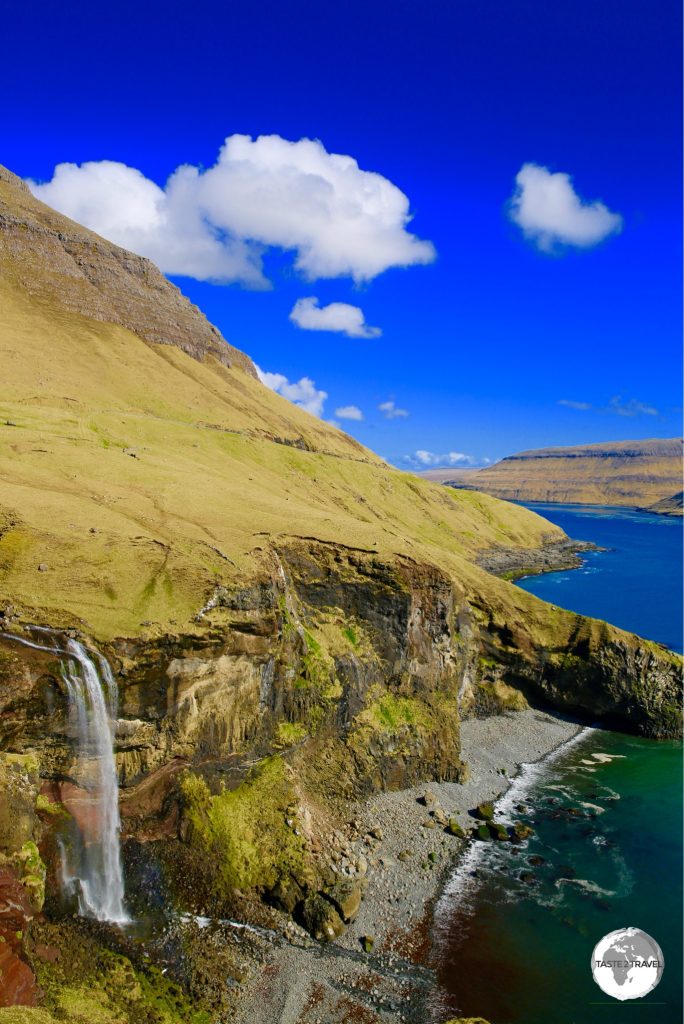 No shortage of spectacular scenery on the Faroe Islands, including this dramatic waterfall plunging onto a remote pebble beach on the island of Vagur.