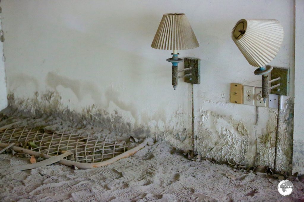 An old bed head and bedside lights, which are now just above the new ground level.