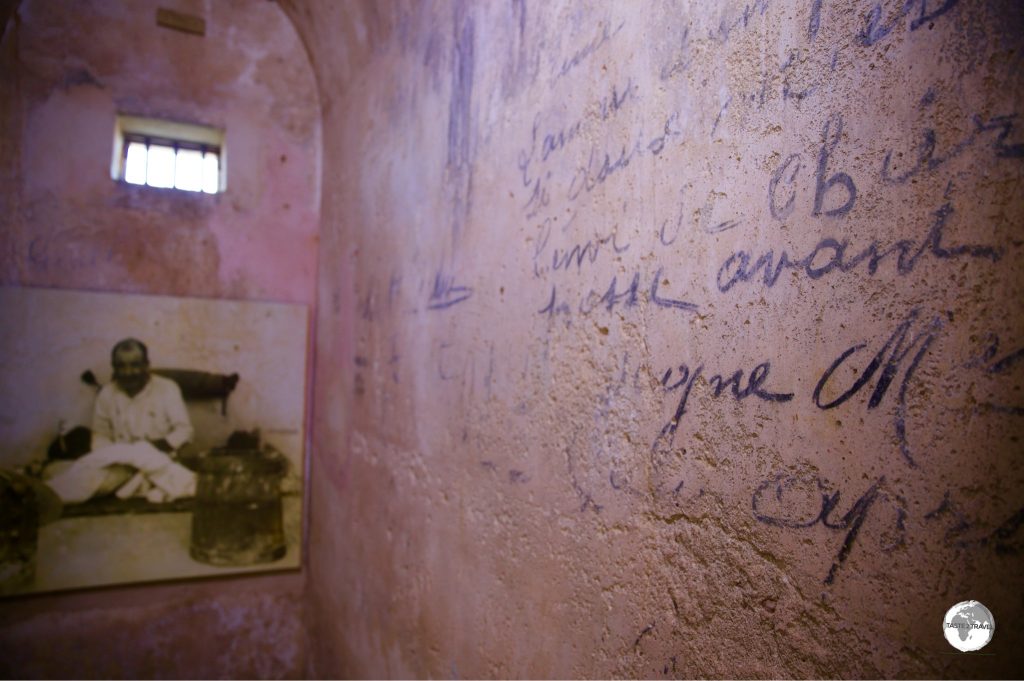 Convict graffiti decorates the wall of a cell at Fort Teremba.