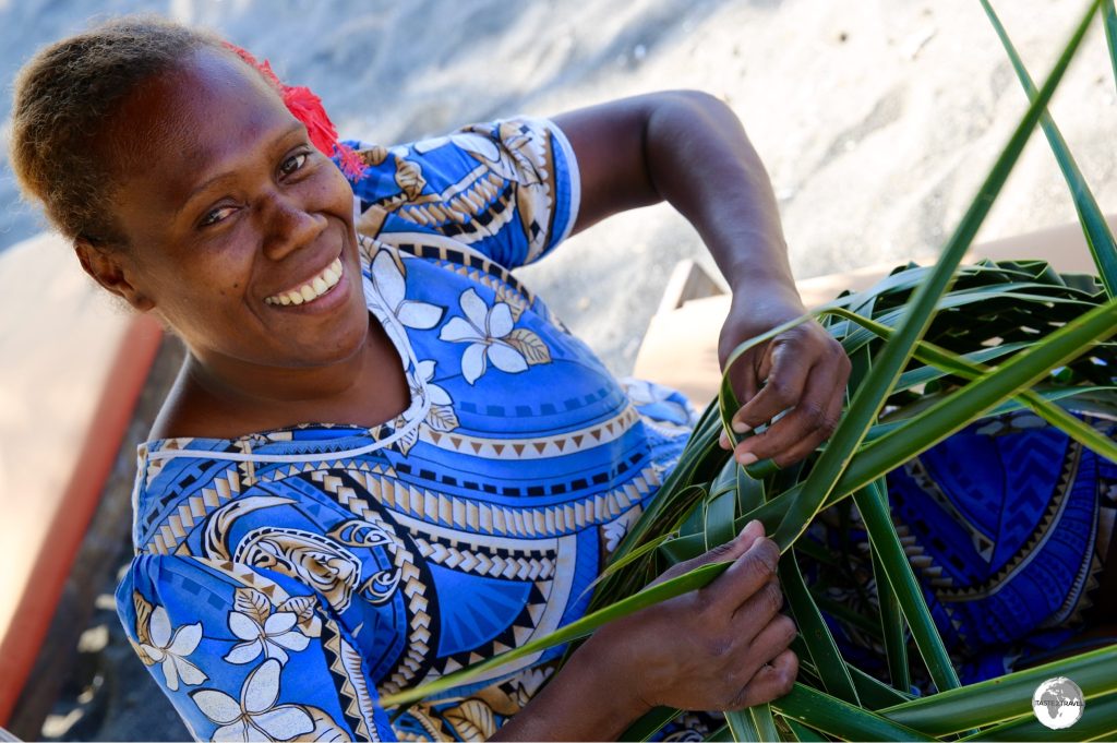 One of the staff members at Friendly Resort weaving a traditional basket.