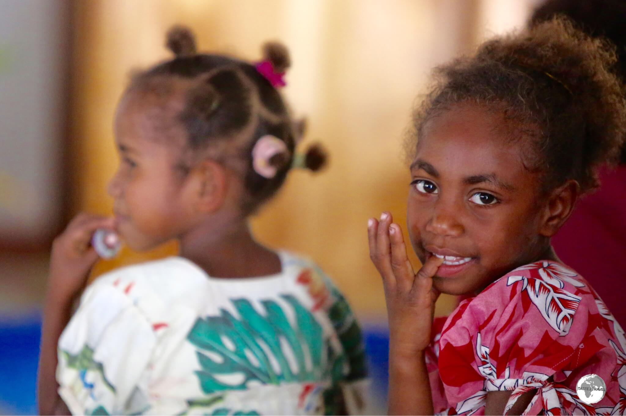 A young girl is distracted during a church service in the village of Louna Sunan.