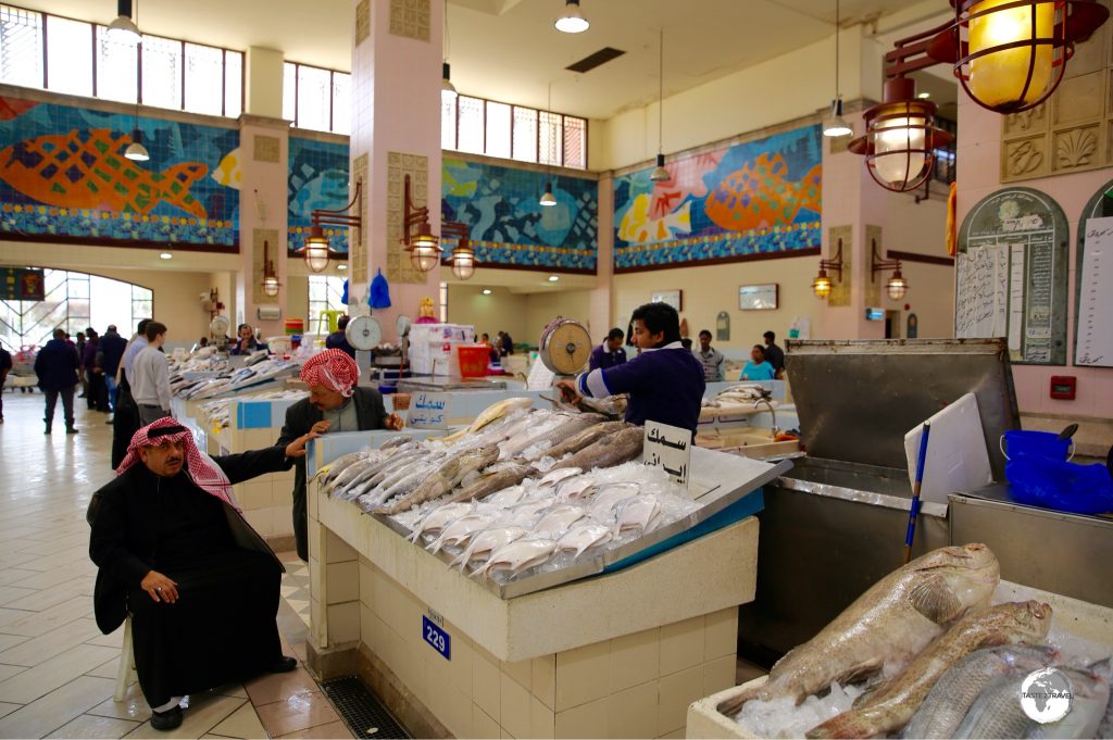 Colourful mosaics, featuring marine life, add to the pleasant atmosphere of the Kuwait fish market.