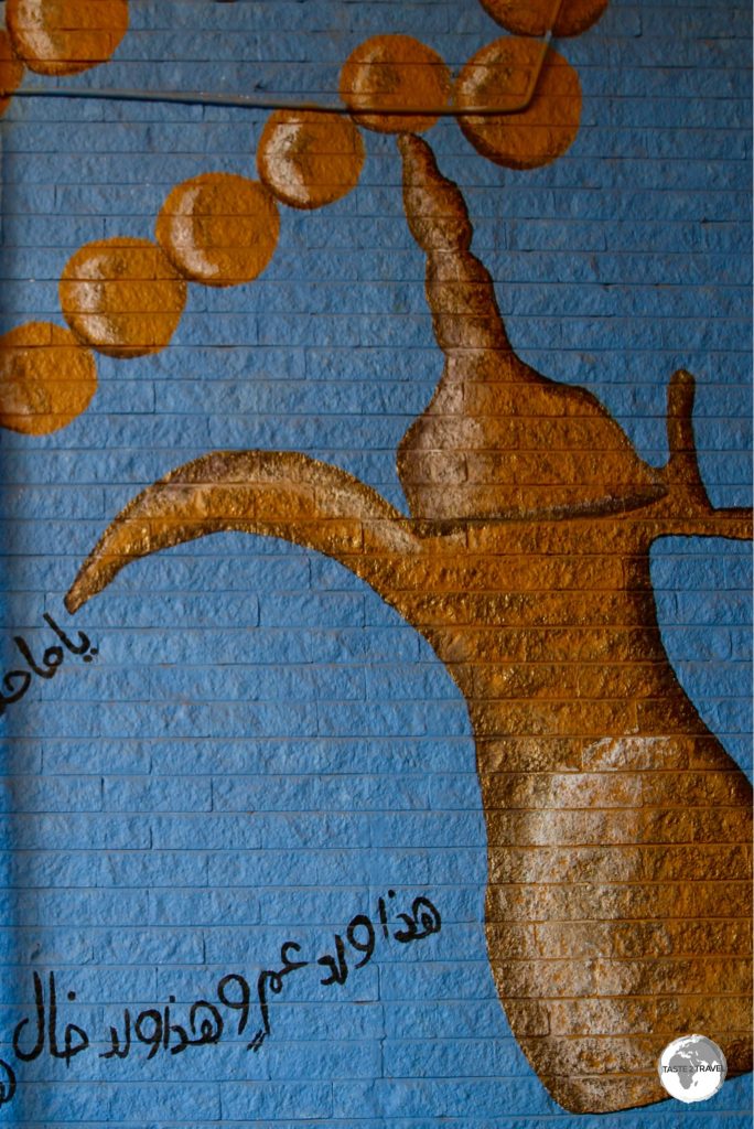 Tea-pot artwork adorns the wall at Souk Al-Mubarakiya.