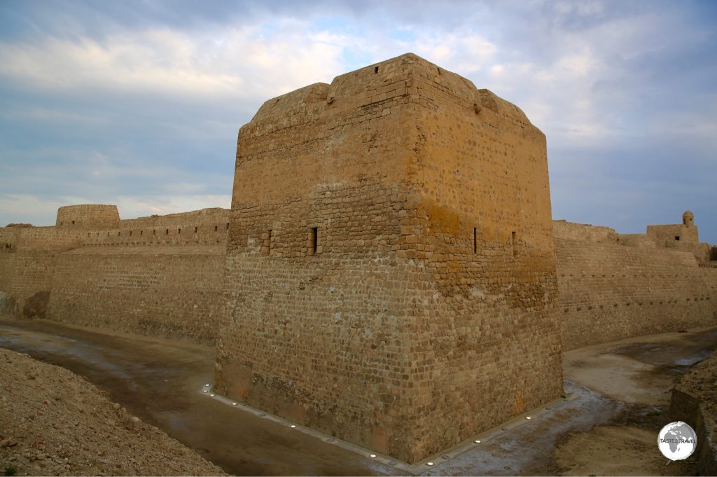 The exterior view of Bahrain fort at dusk.