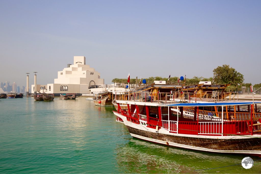 A traditional dhow boat and the Museum of Islamic Art, as seen from the Corniche.