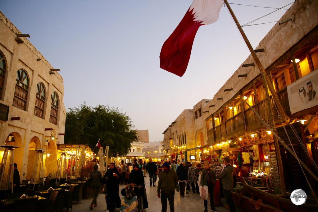 The bustling alleyways of Soul Waqif glow in the evening light.
