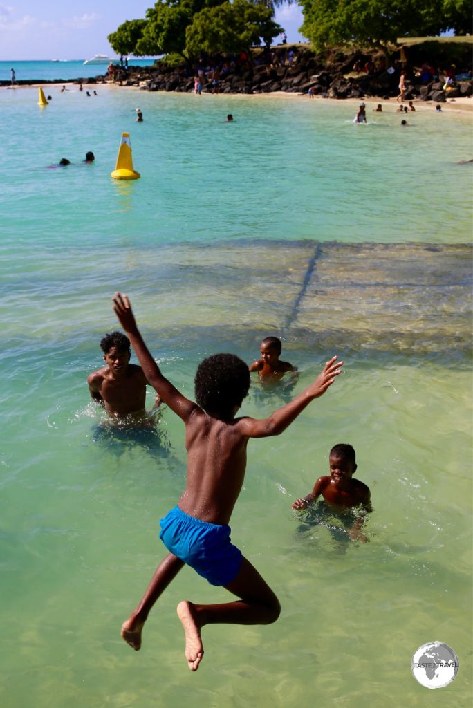 Young Mauritians enjoying the beach at Grand Baie.
