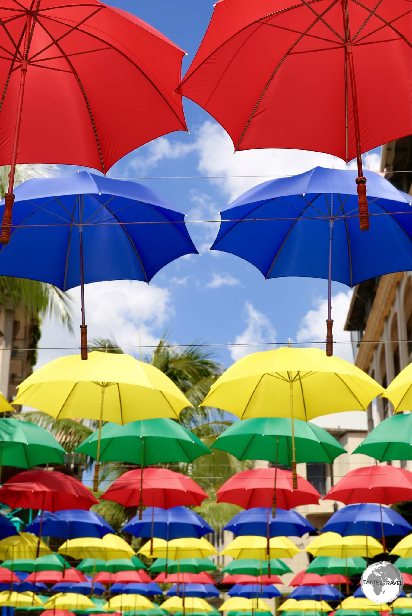 Colourful umbrella artwork provides shade at Le Caudan waterfront complex.