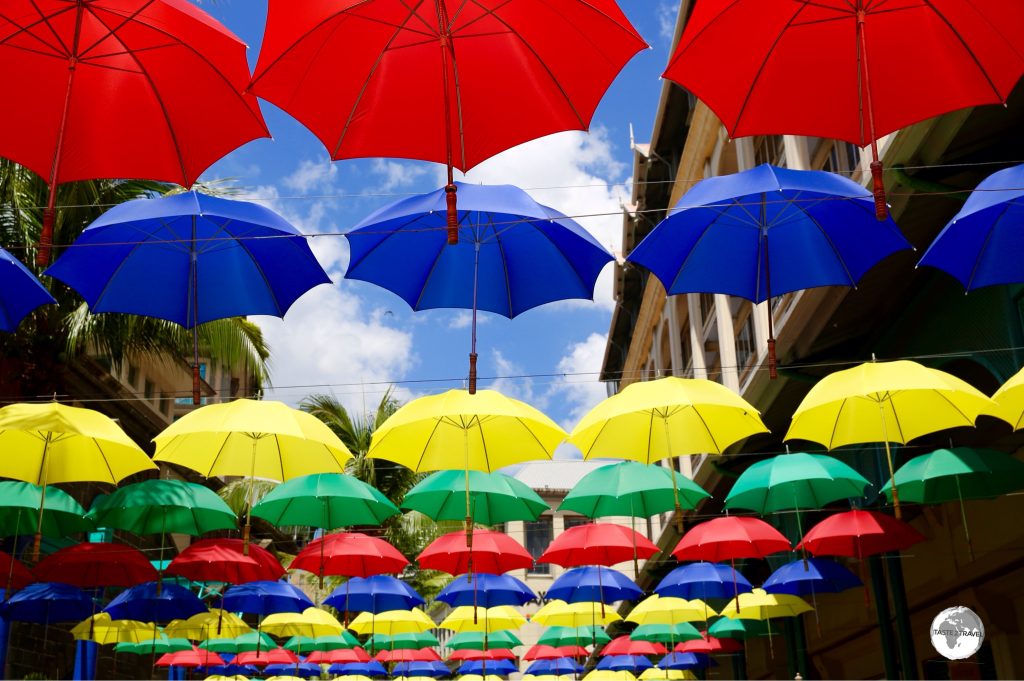Colourful umbrellas provide shade on the pedestrian mall at Le Caudan Waterfront complex.