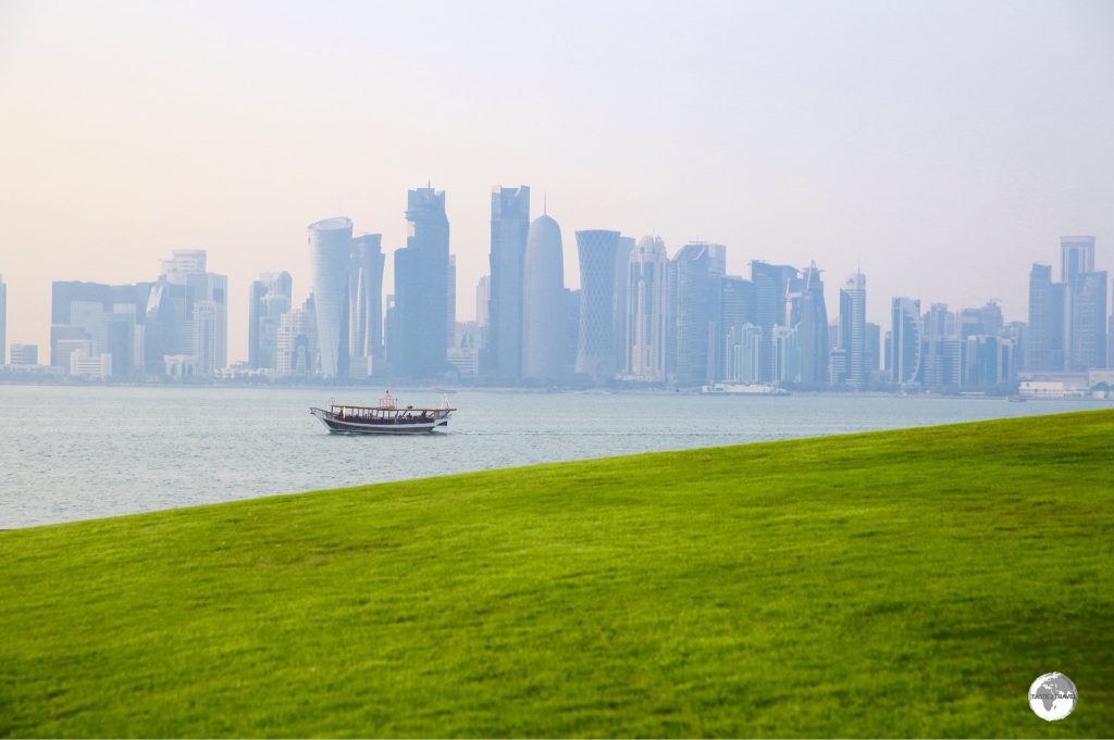 Green grass in the desert and a view of the Doha skyline from MIA park.