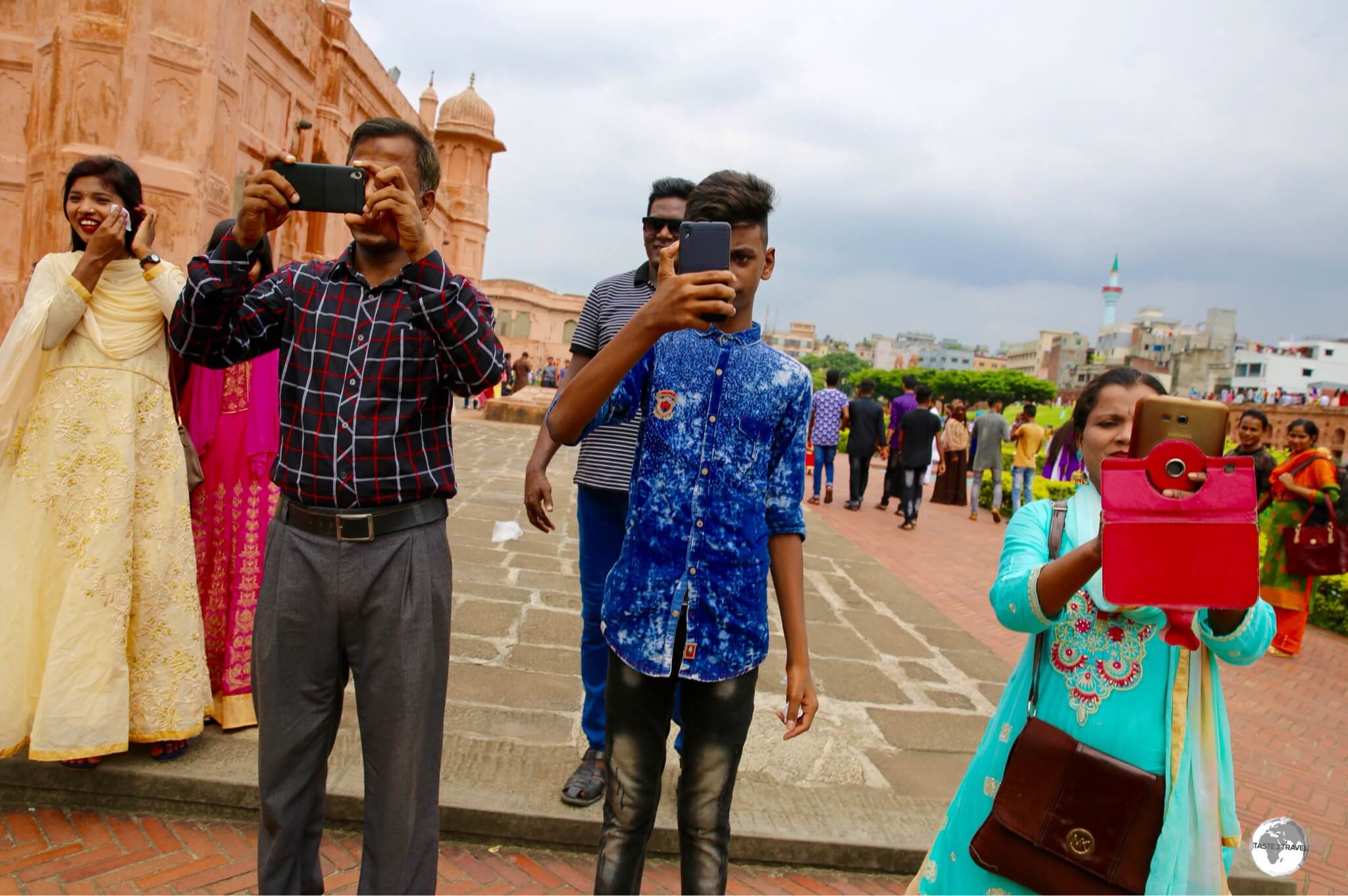 Me photographing three locals who requested I pose for selfies with their family members at Lalbagh fort.