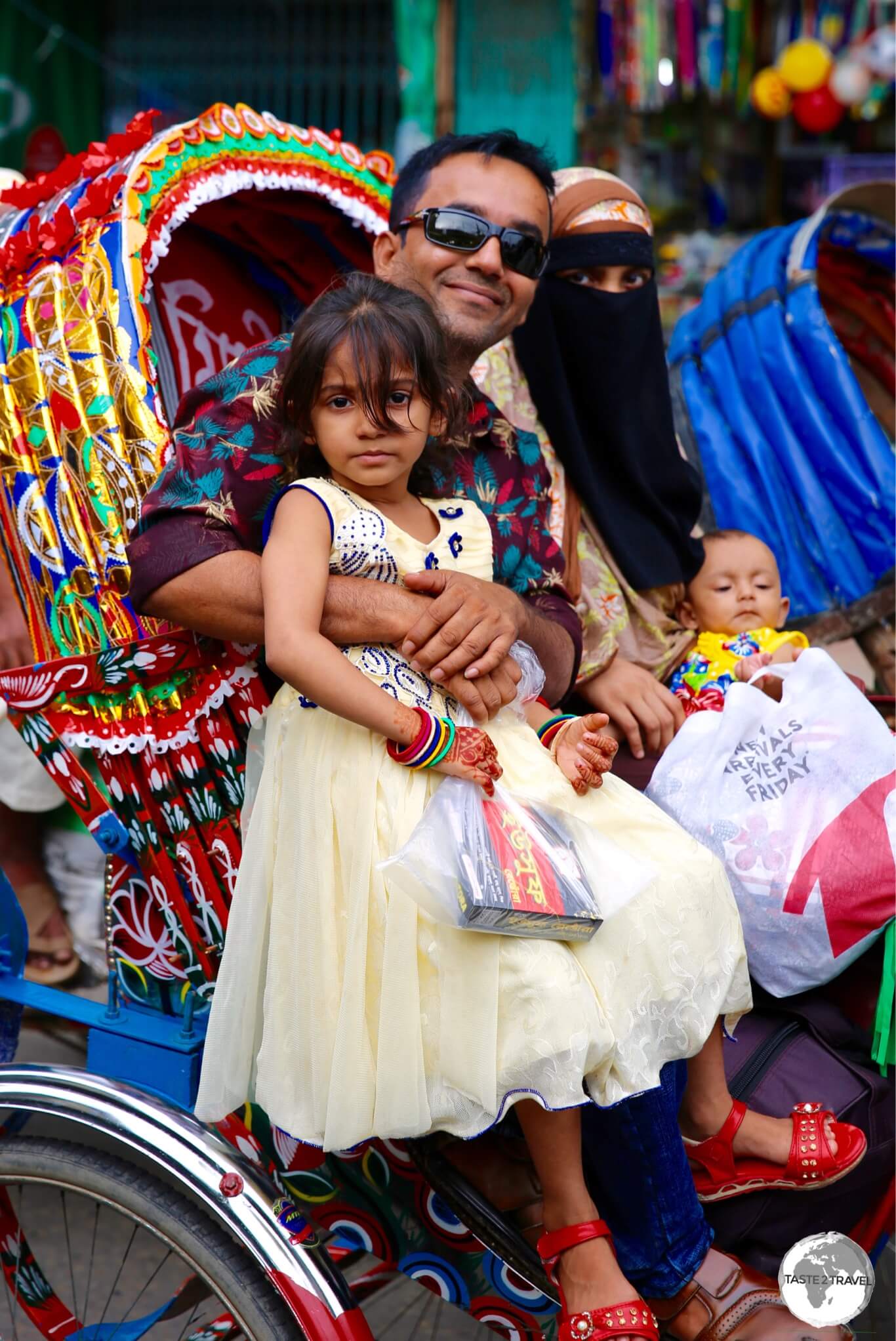 Dhaka Travel Guide: Plenty of room for an entire family on a bicycle rickshaw.