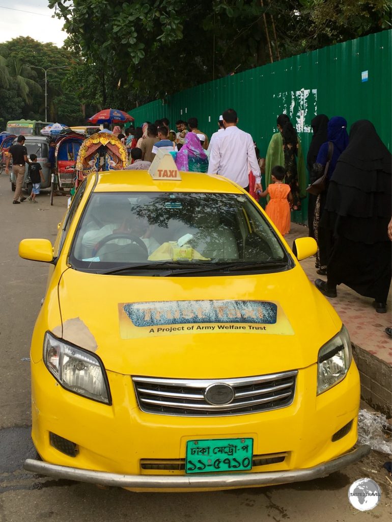Taxis in Dhaka are well out-numbered by the more numerous rickshaws.