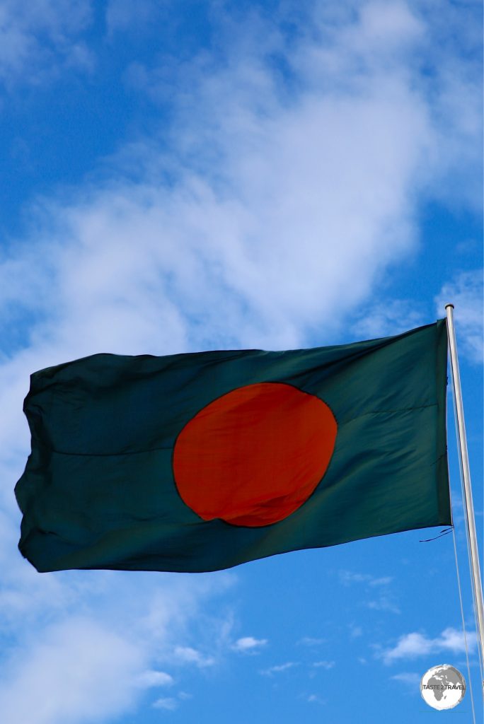 The flag of Bangladesh flying at the Eternal Flame monument.
