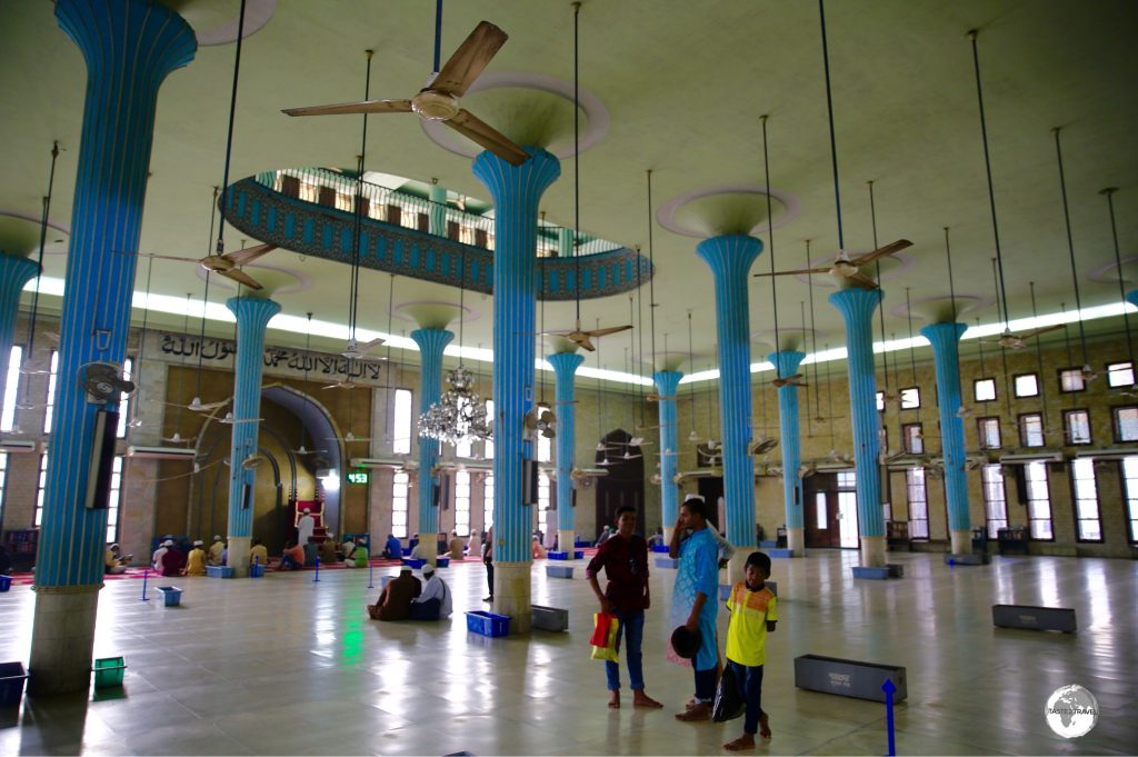 Turquoise-coloured columns provide a splash of colour in the otherwise austere interior of the Baitul Mukarram mosque.