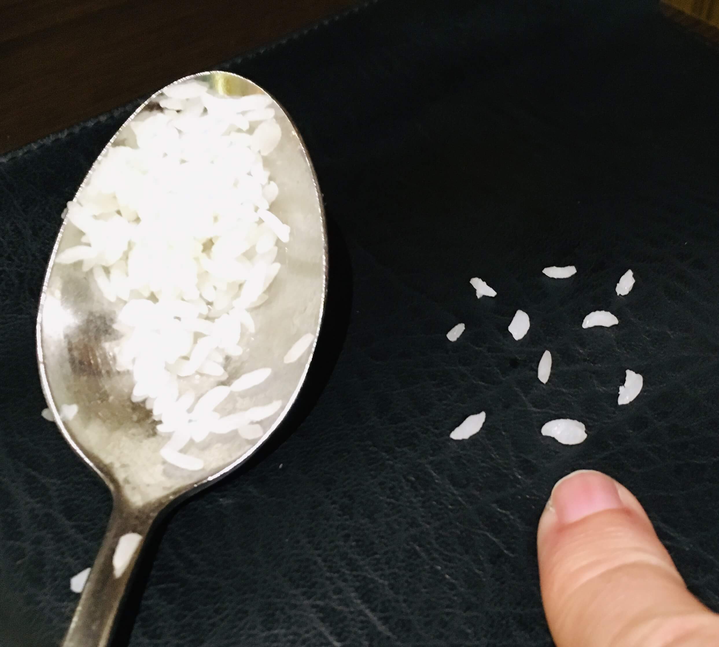My little finger provides a sense of scale against the tiny Chinigura grains.